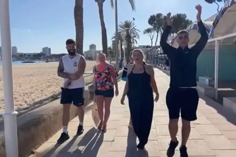 Tourists arrive on Magaluf Beach